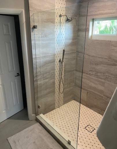 Glass shower enclosure with diamond tile floor