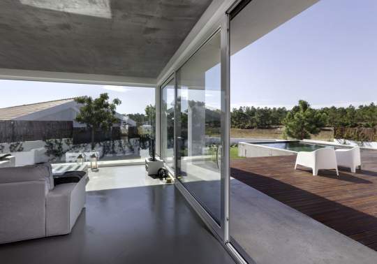 Large sliding glass doors leading out to elegant pool deck