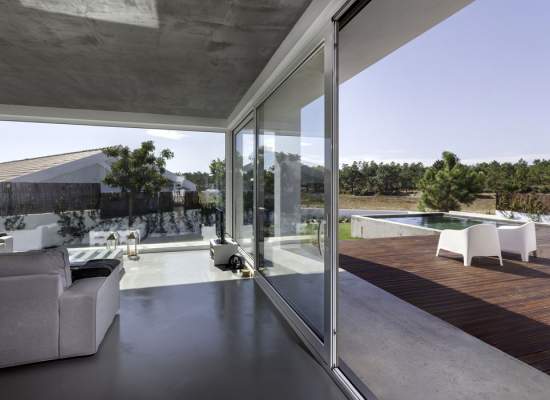 Large sliding glass doors leading out to elegant pool deck