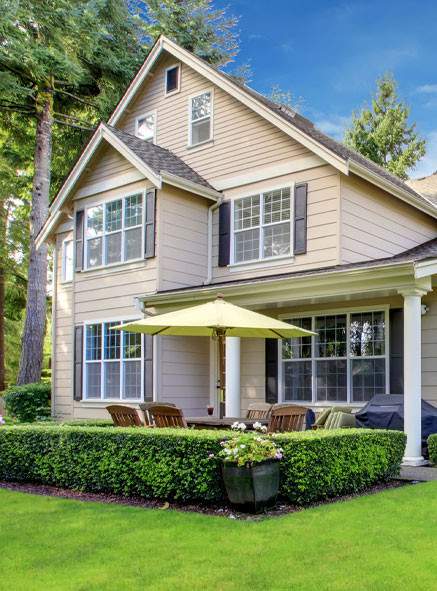 Brown wooden house with yellow patio umbrella